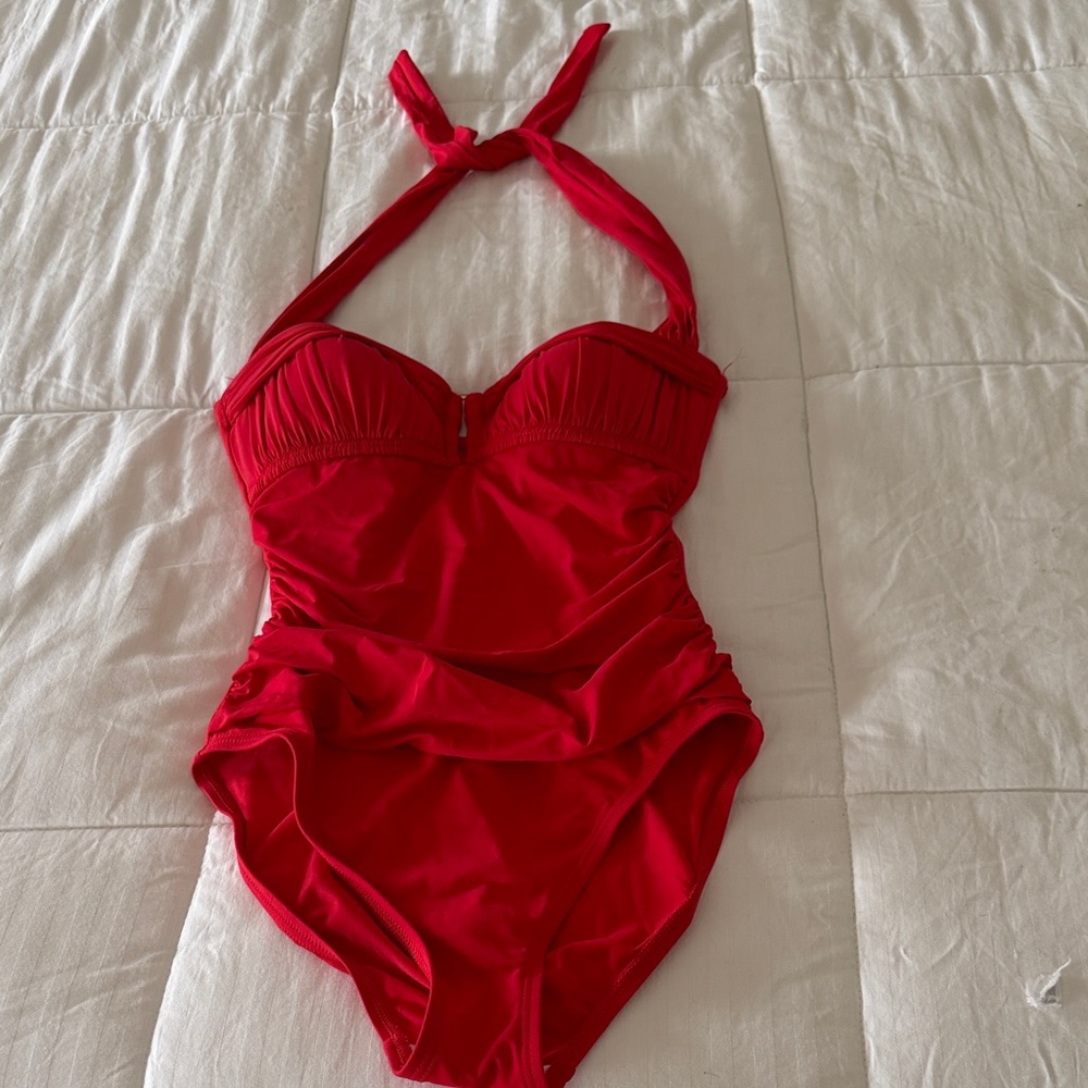 Woman’s red shirred one piece bathing suit